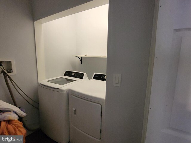 clothes washing area featuring independent washer and dryer