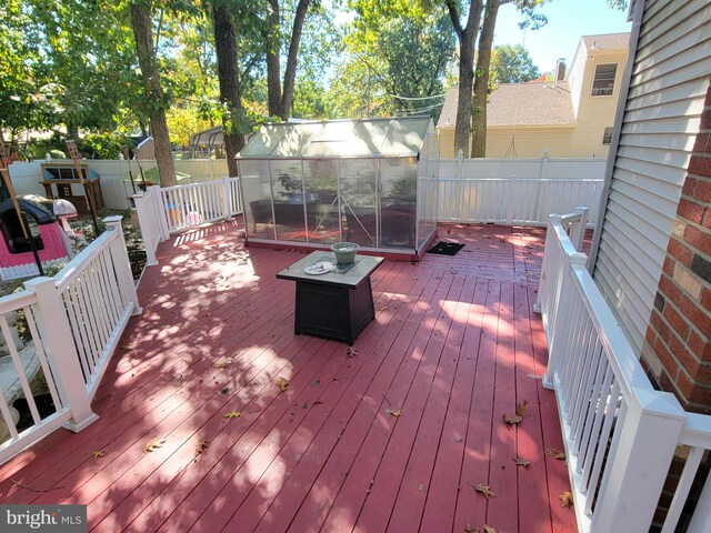 deck featuring an outdoor structure