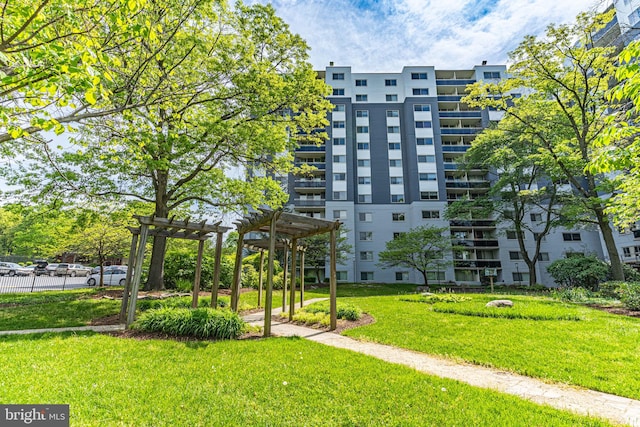 view of property's community with a pergola and a yard