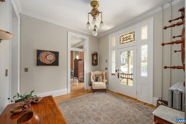 entryway featuring hardwood / wood-style floors and ornamental molding