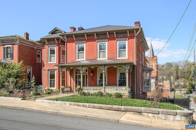 italianate home with a front lawn and a porch