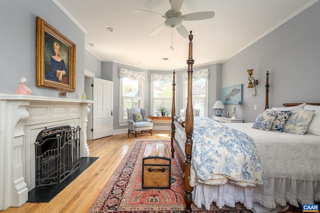 bedroom featuring ceiling fan, ornamental molding, and light hardwood / wood-style floors