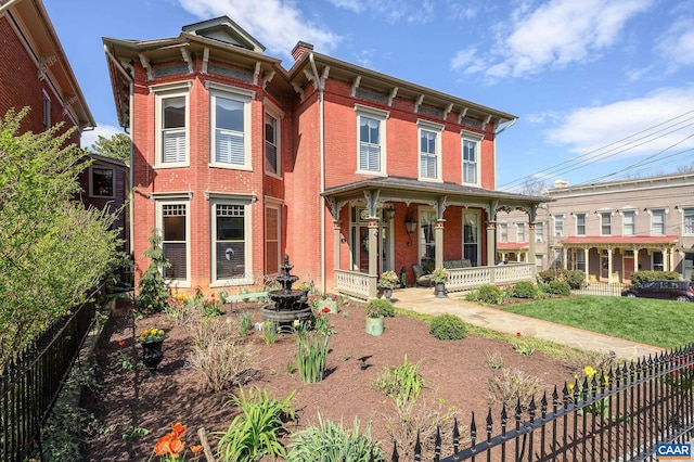 italianate house featuring a front yard and a porch