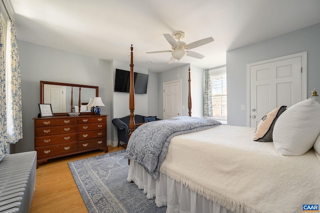 bedroom with light hardwood / wood-style floors and ceiling fan