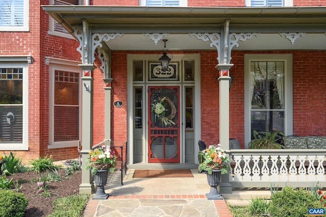 view of exterior entry with covered porch