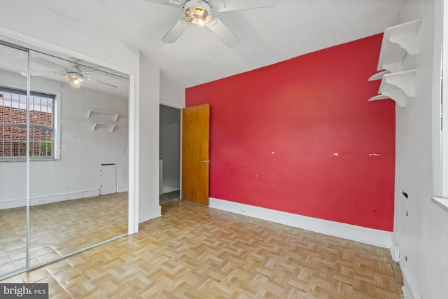 unfurnished bedroom featuring parquet flooring and ceiling fan