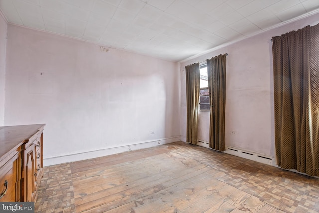 unfurnished room with parquet floors and baseboard heating