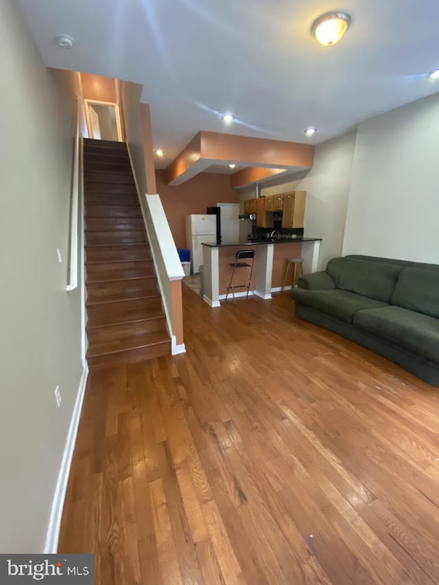 unfurnished living room with hardwood / wood-style floors