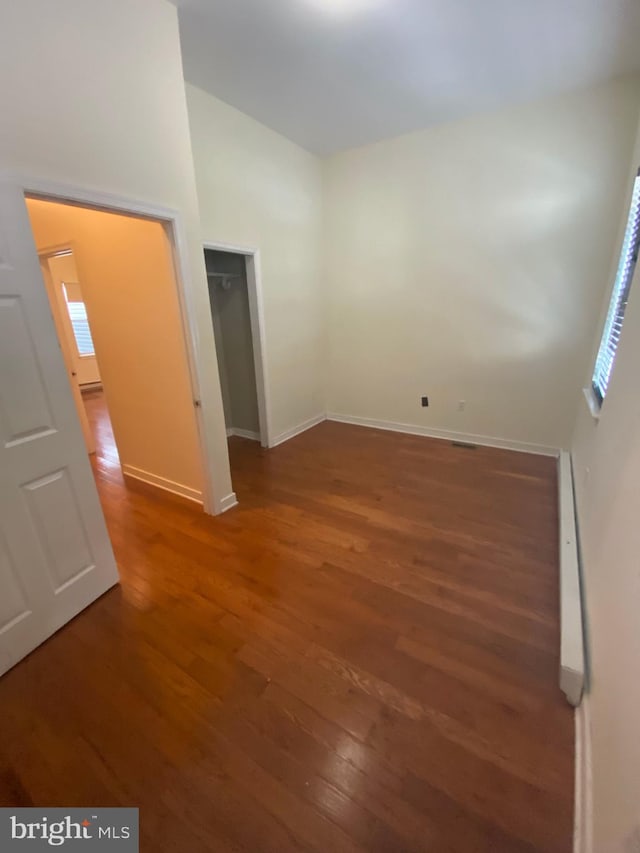 interior space with high vaulted ceiling and hardwood / wood-style flooring