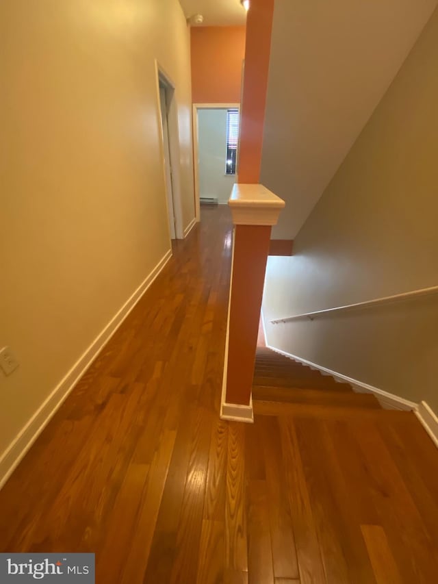 hallway with dark hardwood / wood-style flooring and a baseboard radiator