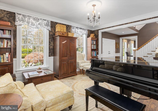 interior space with a healthy amount of sunlight, crown molding, a chandelier, and light hardwood / wood-style flooring