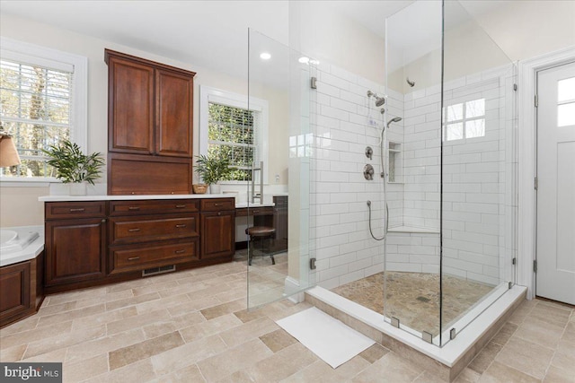 bathroom featuring walk in shower, vanity, and tile floors