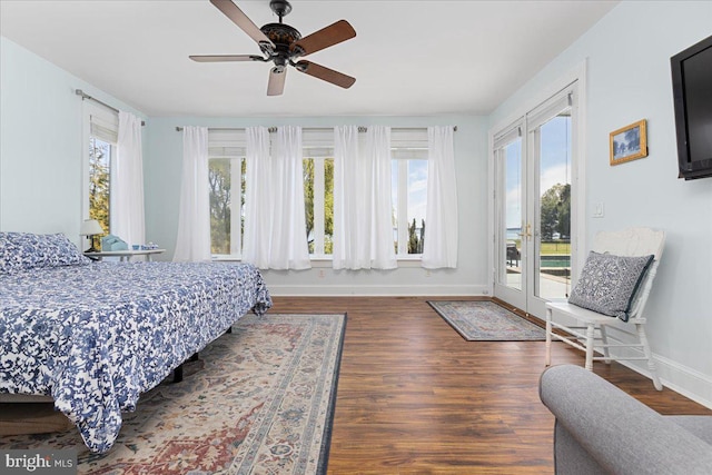 bedroom with access to outside, dark hardwood / wood-style floors, and ceiling fan