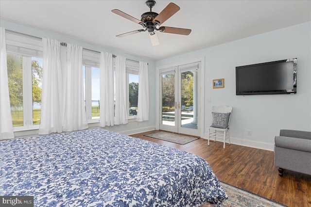 bedroom featuring ceiling fan, wood-type flooring, multiple windows, and access to exterior