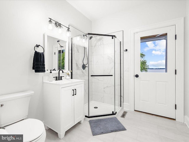 bathroom with tile flooring, plenty of natural light, toilet, and large vanity