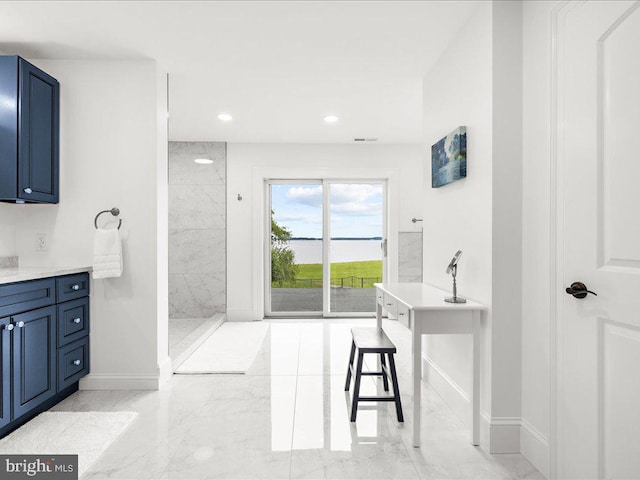 bathroom with tile floors and vanity