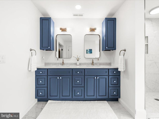 bathroom with vanity with extensive cabinet space, dual sinks, and tile floors