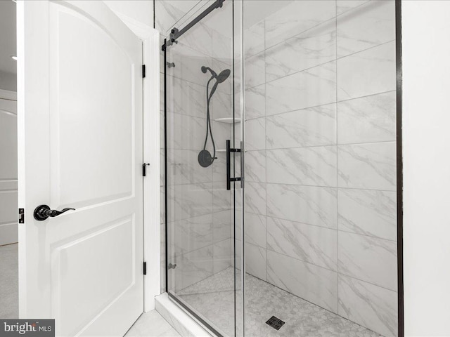 bathroom with walk in shower and tile flooring