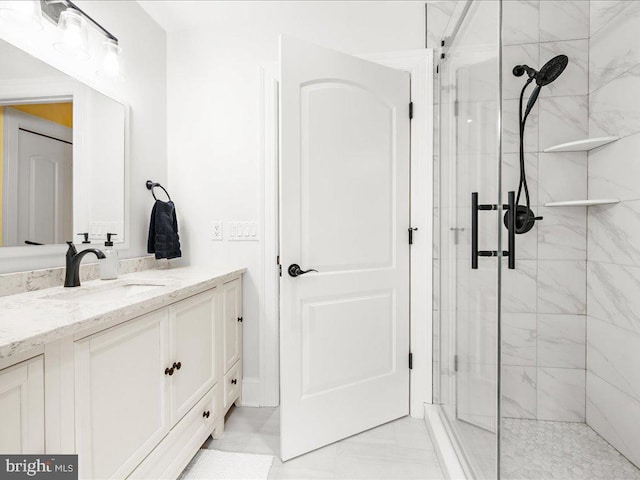 bathroom with vanity, tile floors, and a shower with door