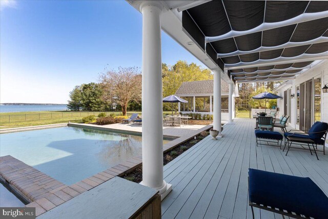 wooden terrace featuring a fenced in pool