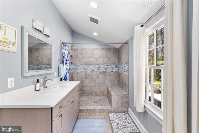 bathroom featuring a shower with curtain, lofted ceiling, vanity, and tile floors