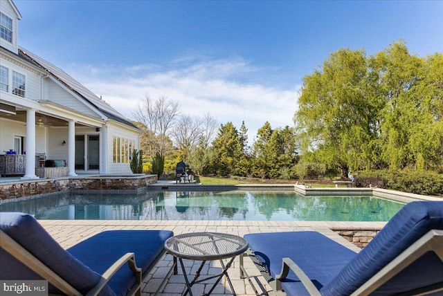 view of swimming pool featuring a patio