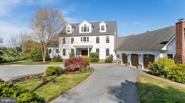 view of front of home with a garage and a front lawn