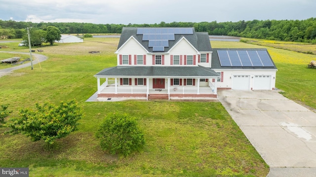 view of front of property with a front lawn, a garage, solar panels, and a porch