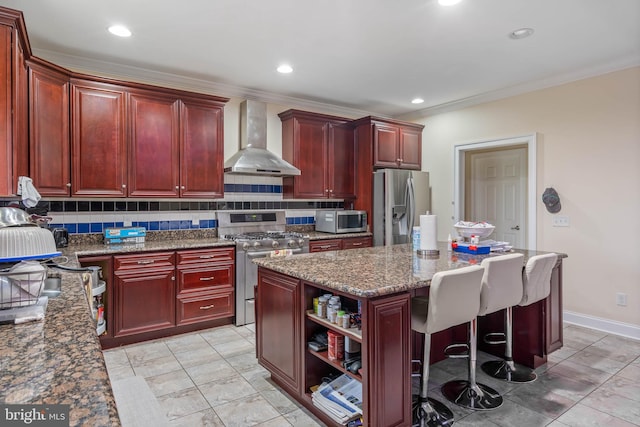 kitchen with tasteful backsplash, light tile flooring, a kitchen island, wall chimney exhaust hood, and appliances with stainless steel finishes