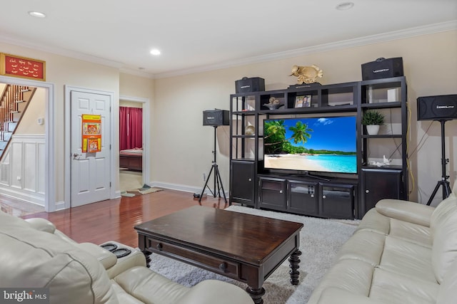 living room with crown molding and hardwood / wood-style floors