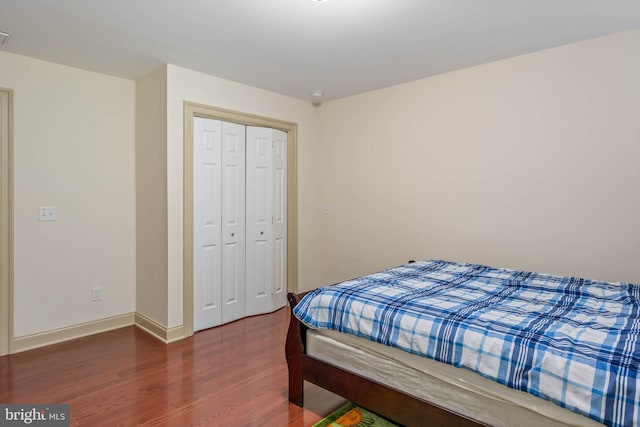 bedroom featuring a closet and dark wood-type flooring