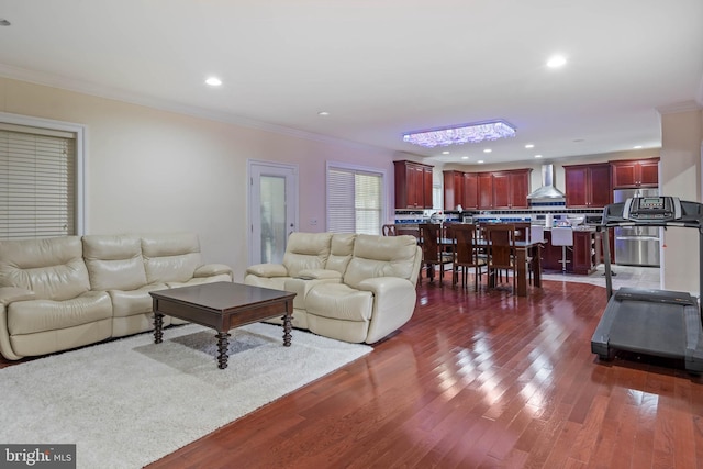 living room featuring wood-type flooring and ornamental molding