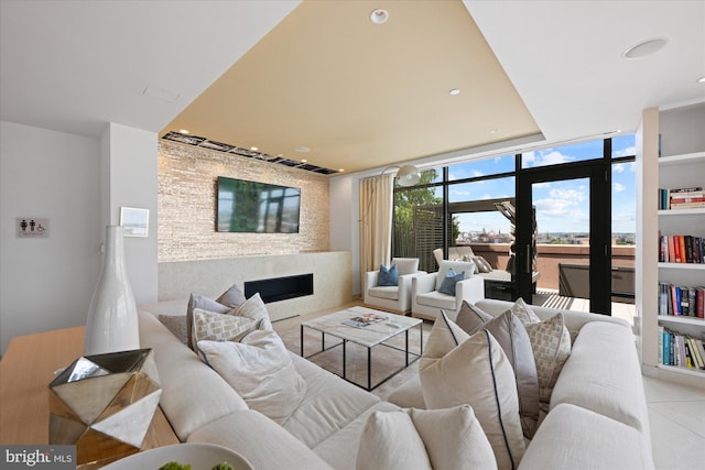 tiled living room featuring a wall of windows