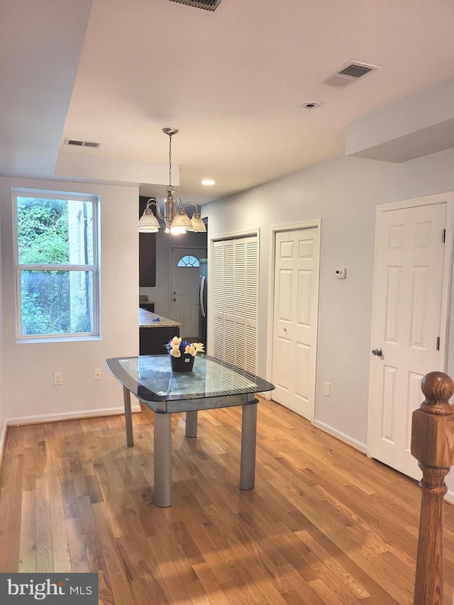 recreation room featuring hardwood / wood-style flooring and a chandelier