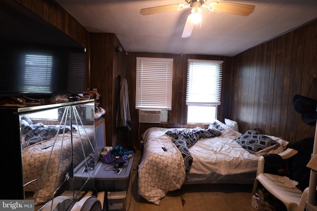 bedroom featuring ceiling fan, wood walls, and cooling unit