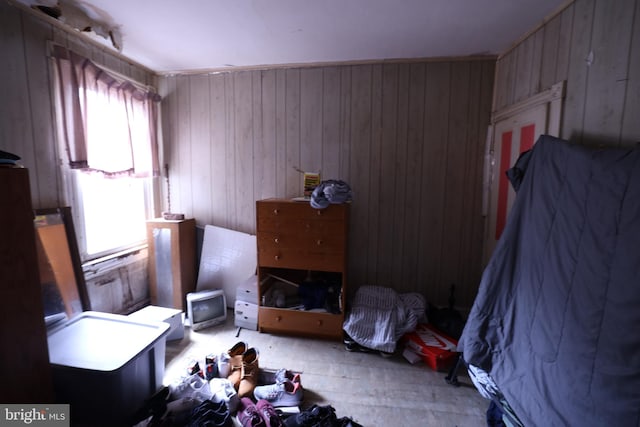 bedroom featuring wooden walls