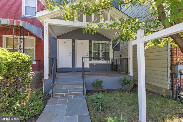 property entrance with covered porch