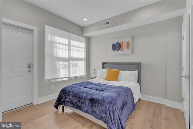 bedroom with hardwood / wood-style flooring