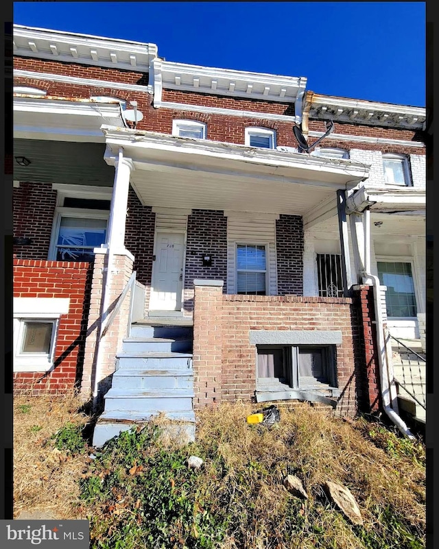 townhome / multi-family property featuring a porch