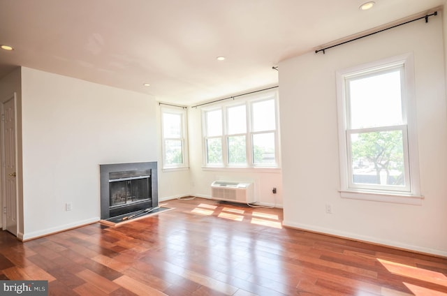 unfurnished living room with wood-type flooring