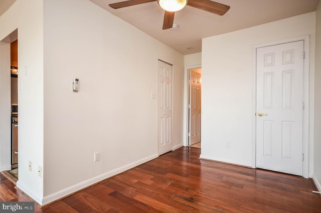 unfurnished bedroom featuring dark hardwood / wood-style floors and ceiling fan