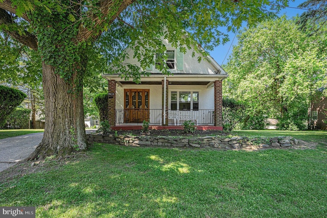 view of front of property with a porch and a front yard