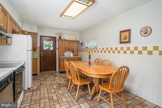 dining area with tile walls