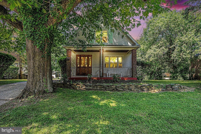 view of front facade featuring a lawn and a porch