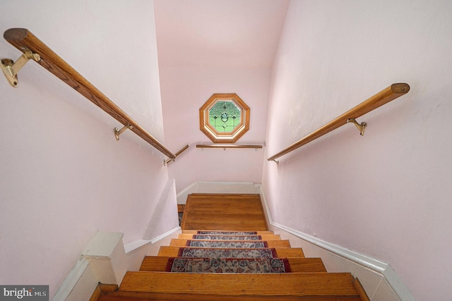 staircase featuring a towering ceiling