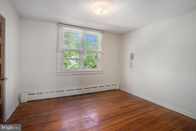 unfurnished room with dark hardwood / wood-style floors, baseboard heating, and ornamental molding