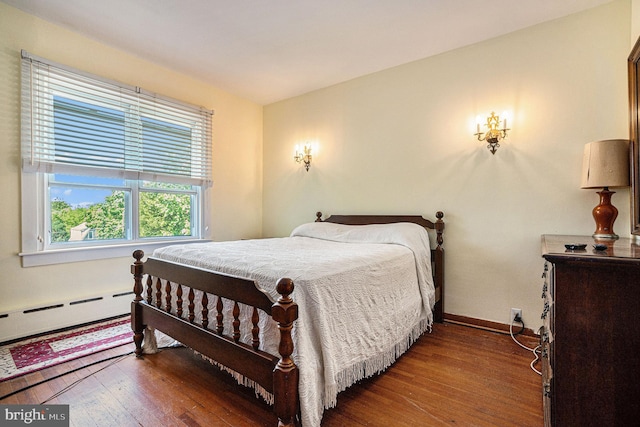 bedroom featuring hardwood / wood-style flooring and a baseboard radiator