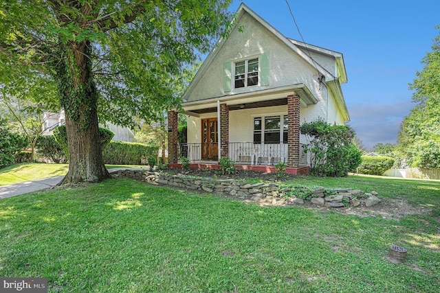 view of front of property with covered porch and a front lawn