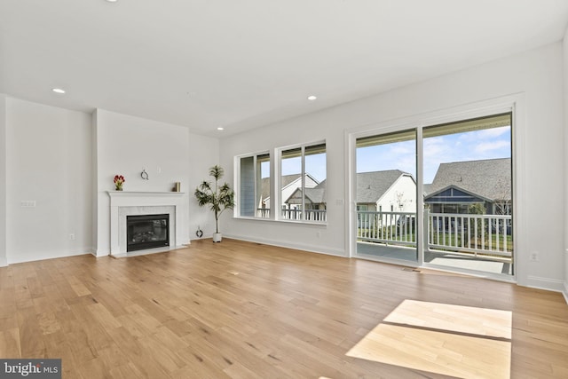 unfurnished living room featuring light hardwood / wood-style floors and a fireplace