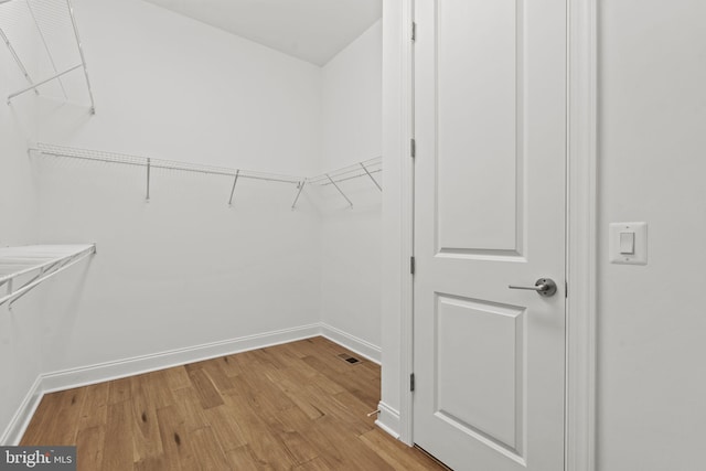 walk in closet featuring light hardwood / wood-style flooring